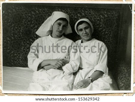 UKRAINE - CIRCA 1957: An antique photo shows Two young women is nurses Oncology Center, Vorochilovgrad, now Lugansk, Ukraine, 1957