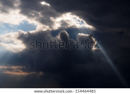 ray of sunshine breaks through the storm clouds