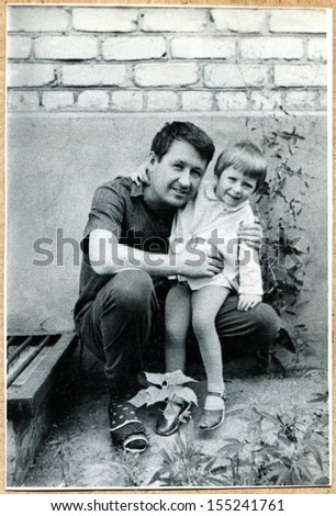 UKRAINE - CIRCA 1970: An antique photo shows man with daughter, Voroshilovgrad, now Lugansk,  1970