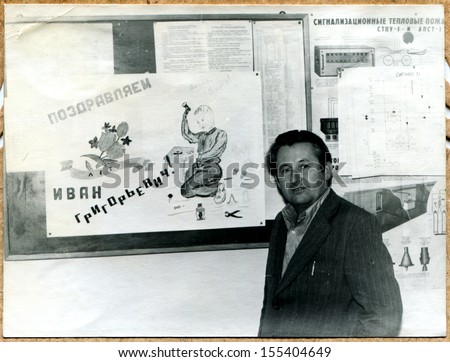 UKRAINE - CIRCA 1969: An antique photo shows man against the wall newspaper, in which he congratulated on his birthday radio workshop staff, Voroshilovgrad, now Lugansk, 1969