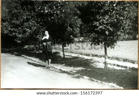 GREECE - 1982: woman on the background of orange trees, Athenes, Greece, 1982
