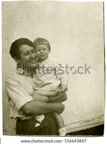 VOROSHILOVGRAD - CIRCA 1964: happy father holding his daughter, Voroshilovgrad, now Lugansk, Ukraine, 1964. Name of girl is Larisa, 3 years old.