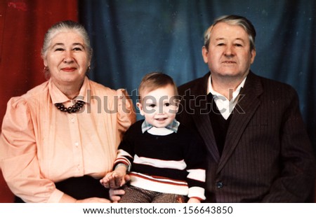 ORSK - CIRCA 1992: studio photography Grandparents with grandson, Orsk, Soviet Union, December, 1992 Name of boy is Nikolay, 2  years old.