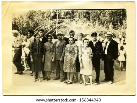 USSR - CIRCA 1950s: group of people in formal attire at a fountain on a sunny day, the Soviet Union, 1950s