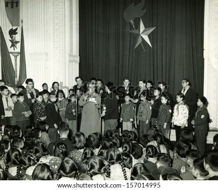 CHINA - CIRCA 1958: members of the Soviet delegation to the stage during a meeting with Chinese schoolchildren, Chinese People\'s Republic, 1958