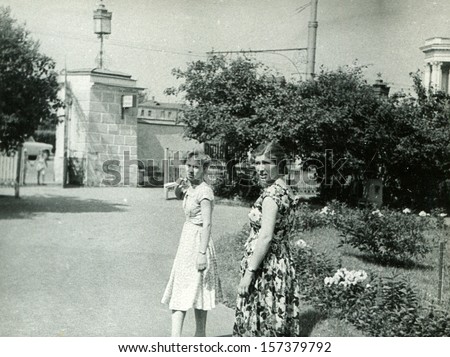 MOSKOW - CIRCA 1958: Two young woman taking a walk in the Exhibition of Economic Achievements, Exhibition Center, Moscow, 1958