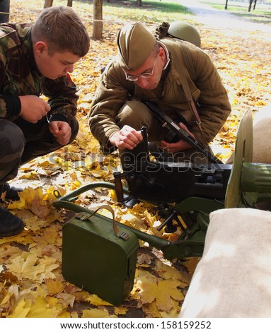 LUGANSK - Oct 13: Club members with a machine gun Maxim . Cossack Historical Club \