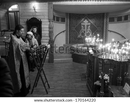 Ukraine, Lugansk - January 7, 2014 Orthodox Christians from Lugansk celebrated Christmas in the Baptistary of the Our Lady of Tenderness temple. Priests carry out a Christmas public prayer