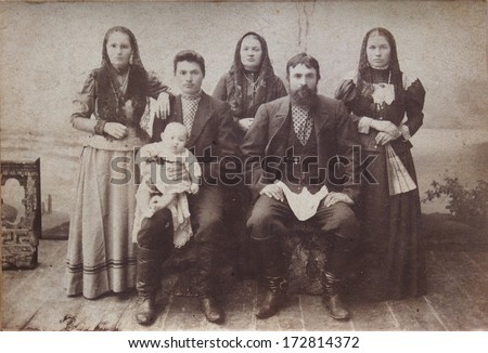 RUSSIAN EMPIRE, UKRAINE, LUGANSK  - CIRCA 1910s: An antique photo shows studio family portrait Photo Studio A. Yukhnov. Russian text is A. Yukhnov