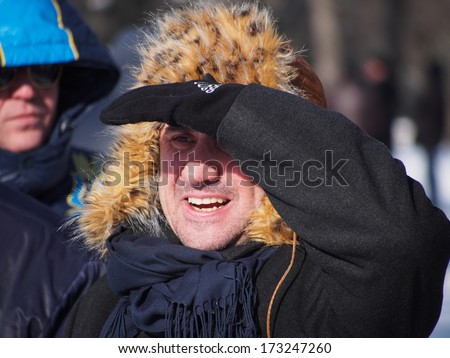 LUGANSK, UKRAINE - JANUARY 26, 2014: Provocateur descended beyond the opposition rally, watching events from afar