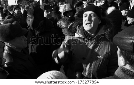 LUGANSK, UKRAINE - JANUARY 26, 2014: Man tries to provoke the opposition rally. Despite laws adopted by Verkhovna Rada of Ukraine, in violation of procedure January 16, 2014, activists come to protest