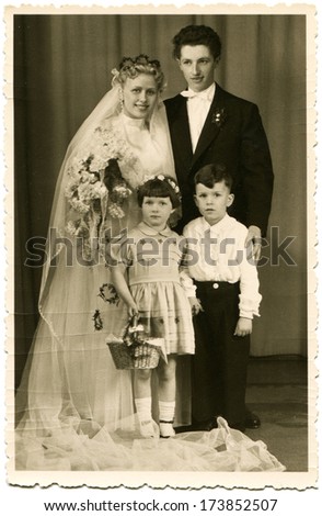 GERMANY - 1950s: An antique photo shows studio portrait of the bride and groom with a girl and a boy