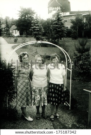 GERMANY -  CIRCA 1960s: An antique photo shows three middle-aging women in the garden