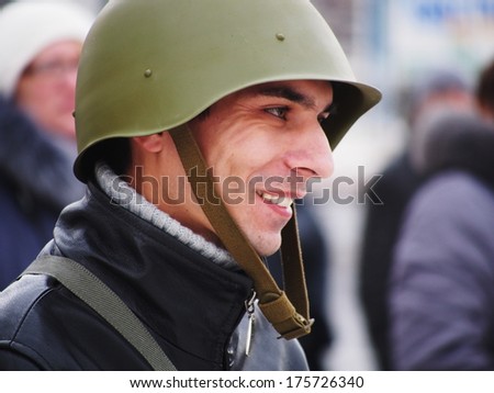 UKRAINE, LUGANS - FEBRUARY 9, 2013: One of the organizers of the rally in the Soviet military helmet World War II.  Rally in support of Berkut no more than 30-40 people.