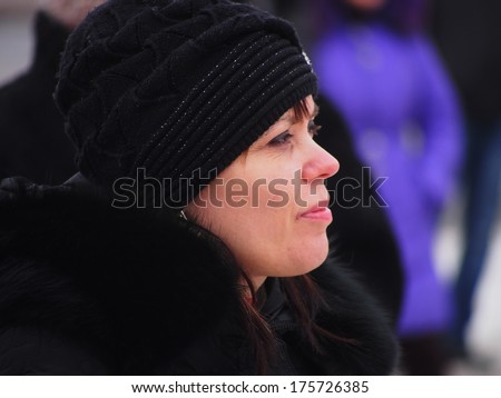 UKRAINE, LUGANS - FEBRUARY 9, 2013: Woman is a rally participant. Organized under the flags of Russia and Ukrainian SSR defunct rally in support of special forces Berkut gathered about 30-40 people.