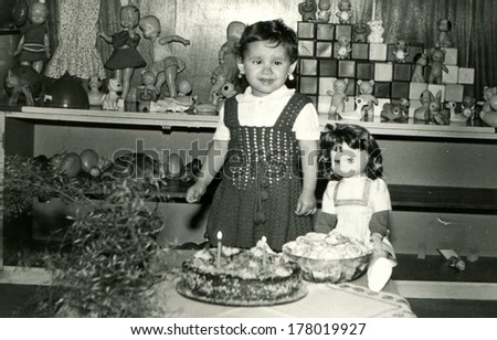 BULGARIA - APRIL 1, 1983:  girl on her birthday, the village Vodice, community Popovo, Targovishte region, Bulgaria, April 1, 1983. Name od girl is Tanya, 2 years old