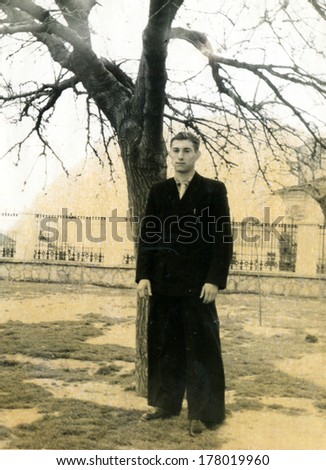 USSR - CIRCA 1950s: man in formal dress stay under the tree, USSR, 1950s