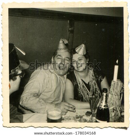 GERMANY -  January 1, 1958: An antique photo shows man and women celebrate Christmas