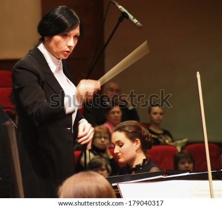 LUGANSK, UKRAINE - February 27. 2014:Lugansk Philharmonic Orchestra performed the Concerto No1 for piano and orchestra by Camille Saint-Saens. Conductor is Catherine Osadchaya, soloist - Irina Burgan.