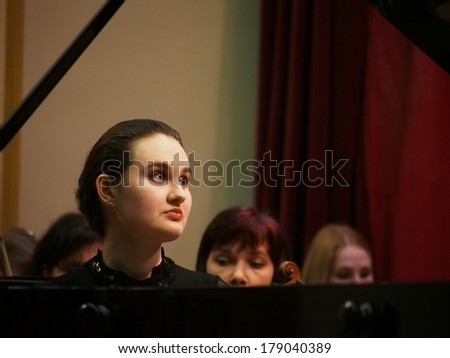 UKRAINE, LUGANSK - FEBRUARY 27 2014:Lugansk Philharmonic Orchestra performed the Concerto No1 for piano and orchestra by Camille Saint-Saens. Conductor is Catherine Osadchaya, soloist - Irina Burgan.