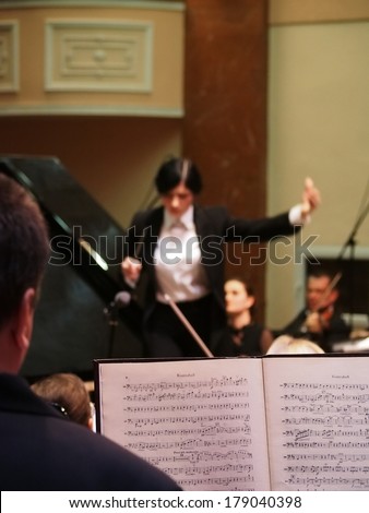 UKRAINE, LUGANSK - FEBRUARY 27. 2014:Lugansk Philharmonic Orchestra performed the Concerto No1 for piano and orchestra by Camille Saint-Saens. Conductor is Catherine Osadchaya, soloist - Irina Burgan.
