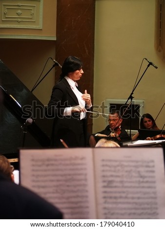 UKRAINE, LUGANSK - FEBRUARY 27,  2014:Lugansk Philharmonic Orchestra performed the Concerto No1 for piano and orchestra by Camille Saint-Saens. Conductor is Catherine Osadchaya, soloist - Irina Burgan.