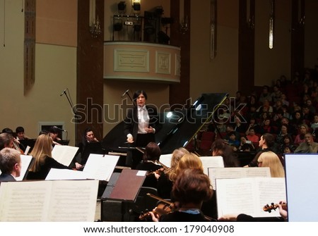 UKRAINE, LUGANSK - FEBRUARY 27,  2014: Lugansk Philharmonic Orchestra performed the Concerto No1 for piano and orchestra by Camille Saint-Saens. Conductor is Catherine Osadchaya, soloist - Irina Burgan.