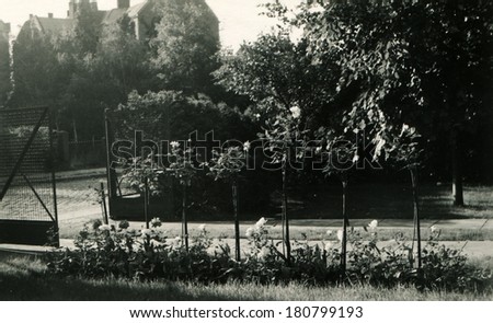 GERMANY - CIRCA 1950s: An antique photo of open gate to the park