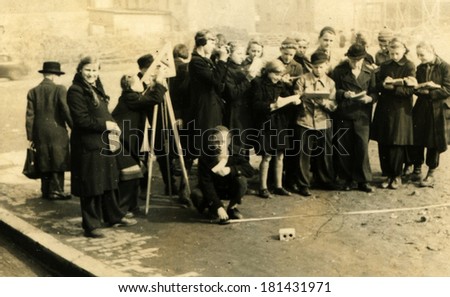 GERMANY - CIRCA 1930s: An antique photo of group of students at a lesson of astronomy, outdoor