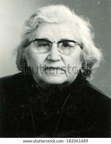 GERMANY - CIRCA 1960s: An antique studio studio portrait of an old woman in eyeglasses
