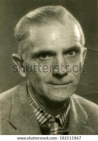 GERMANY, BERLIN - CIRCA 1940s: An antique stadio portrait of middle-aged man in a business suit