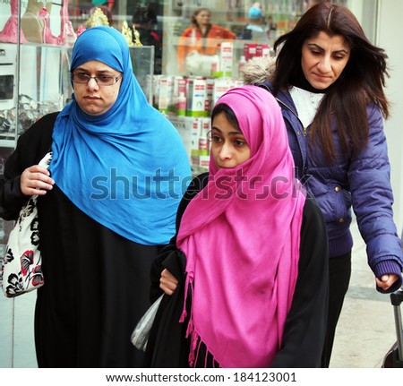 ISTANBUL - Apr 21, 2013: Two women wearing hijabs go to the street on Divan yolu
