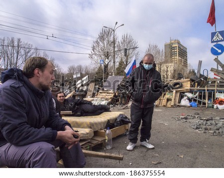 UKRAINE, LUGANSK - April 9, 2014: pro-Russian activists going after a sleepless night at the the second barricade near the Ukrainian regional office of the Security Service in Lugansk