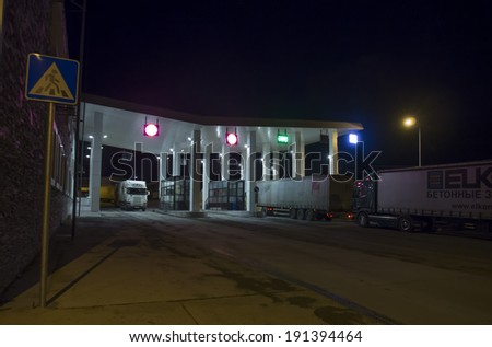 KAZBEGI, GEORGIA - April 29, 2014: Trucks pass customs control at night. Checkpoint on the Georgian military road Kazbegi, Mtskheta, Stepantsminda, Larsi, Georgia at night