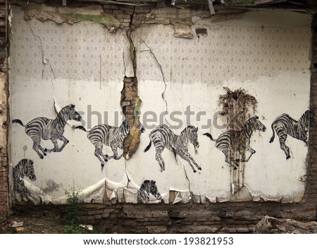 TBILISI, GEORGIA - April 29,  2014: Wallpaper with zebras on the wall of the demolished houses in old city Sololaki in Tbilisi, Georgia