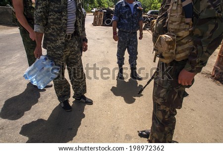 STANITSA LUHANSKAYA, LUHANSK REGION, UKRAINE - June 13, 2014:  Pro-Russian insurgents checkpoint on the old road bridge over the river Seversky Donets at the entrance to the Stanitsa Luhanskaya