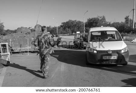 OLEKSANDRIVS\'K, LUHANS\'KA OBLAST, UKRAINE - June 24, 2014: Armed Pro-Russian insurgents check cars