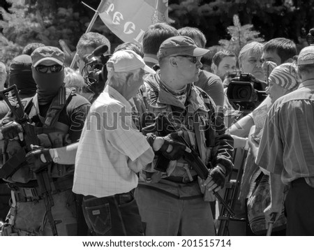 LUHANSK, UKRAINE - June 29, 2014:  Armed representatives of private security company guarding the self-proclaimed Novorossia parliament speaker Oleg Tsarev during a speech at the rally.