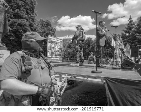 LUHANSK, UKRAINE - June 29, 2014:  Armed representatives of private security company guarding the self-proclaimed Novorossia parliament speaker Oleg Tsarev during a speech at the rally.