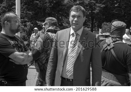 LUHANSK, UKRAINE - June 29, 2014: Armed representatives of private security company guarding the self-proclaimed Novorossia parliament speaker Oleg Tsarev during a speech at the rally