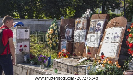 KYIV, UKRAINE - Aug 5, 2014: The young man examines portraits of those killed during the clashes in the Ukrainian capital.