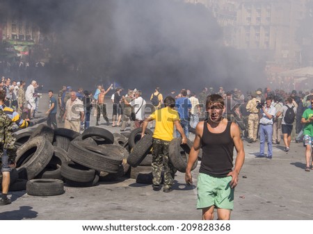 KYIV, UKRAINE - Aug 7, 2014: Activist on the background of barricade.Activists and police have clashed in the Ukrainian capital\'s center after communal workers tried to dismantle the camp.