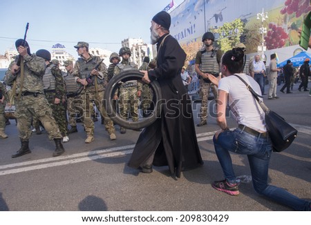 KYIV, UKRAINE - Aug 7, 2014: Woman begs police not to demolish the barricades and tents. Activists and police have clashed in Ukrainian capitals center after communal workers tried to dismantle camp.