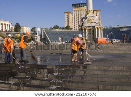KYIV, UKRAINE - 19 AUG, 2014: Workers hose down and clean Maidan as they prepare the Kiev square in readiness for the annual Ukrainian Independence Day celebrations scheduled for August 24th, 2014.