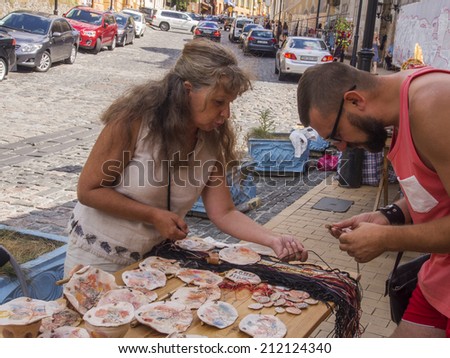 UKRAINE, KYIV - 18 Aug, 2014: Ukrainian woman sells souvenirs, Andrew\'s descent, Kiev, Ukraine