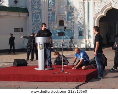 UKRAINE, KYIV - 23 Aug, 2014: Workers prepare the stage for the ceremony. Sophia Square on official flag-raising ceremony in honor of Ukrainian flag. The ceremony was attended by President Poroshenko