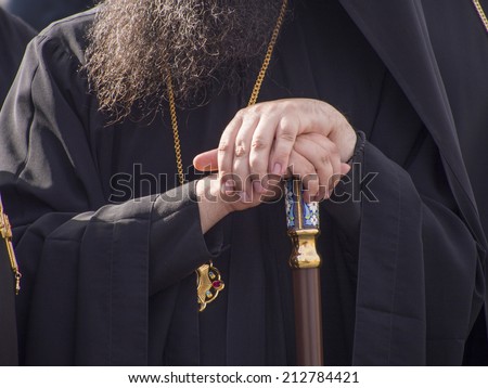 UKRAINE, KYIV - 23 Aug, 2014: Priest\'s hands, leaning on his staff. In Kiev, the first time in five years, was the official military parade. The sixth in the history of independent Ukraine.