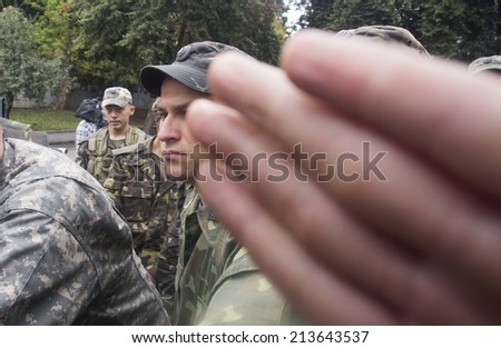 UKRAINE, KYIV - 29 Aug, 2014: Military personnel hold the gate of the Ministry of Defense of Ukraine, hundreds of protesters demanded the purge in the Ministry of Defence.