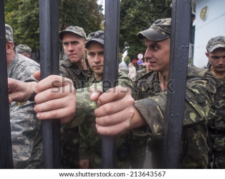 UKRAINE, KYIV - 27 Aug, 2014: Military personnel hold the gate of the Ministry of Defense of Ukraine. Near the building of General Staff in Kiev, hundreds of protesters demanded the purge in Ministry