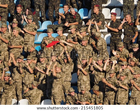UKRAINE, KYIV - September 6, 2014: Fans of the Ministry of Defence are rejoicing in the first goal. In friendly match of pop stars, movies stars, businessmen,and members of Military Forces of Ukraine